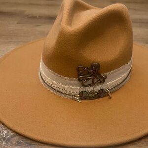 Tan rancher hat with octopus brooch